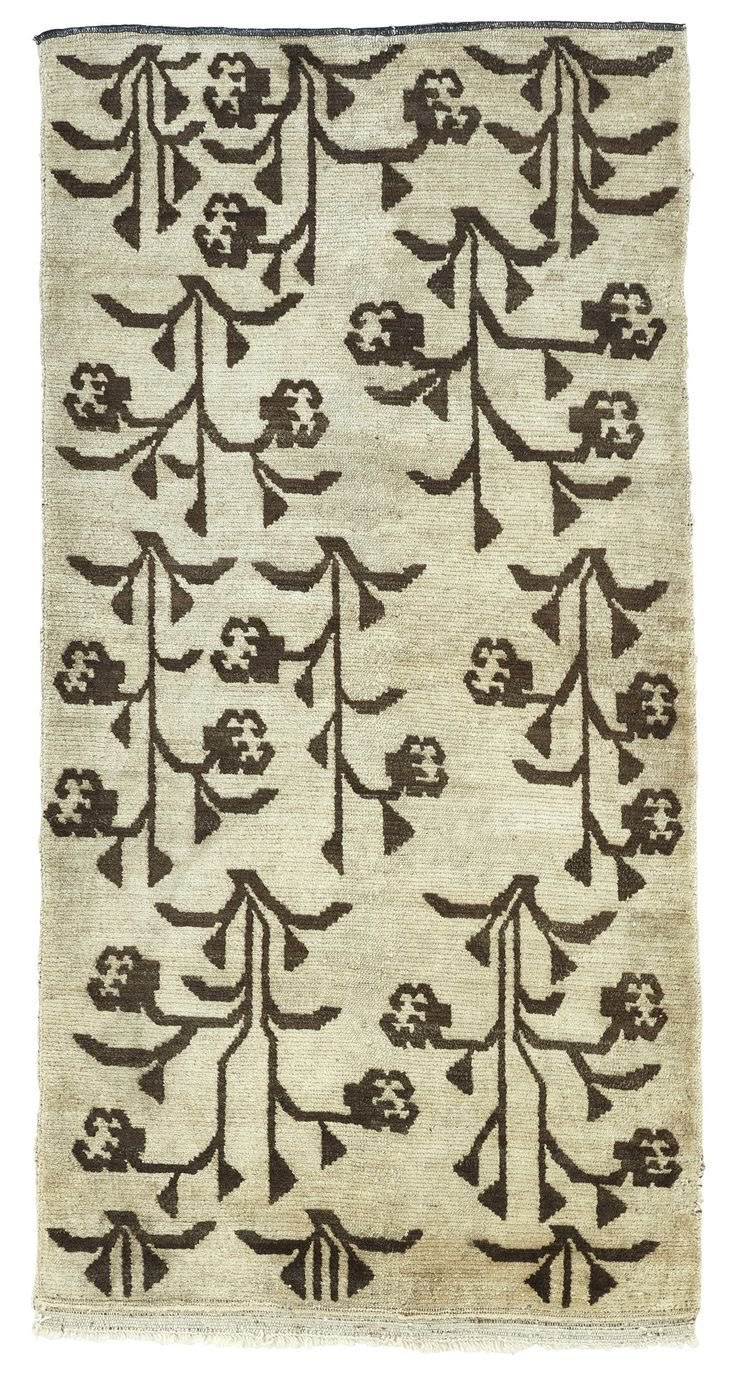 Vintage rug with stylized brown tree and floral motifs on cream