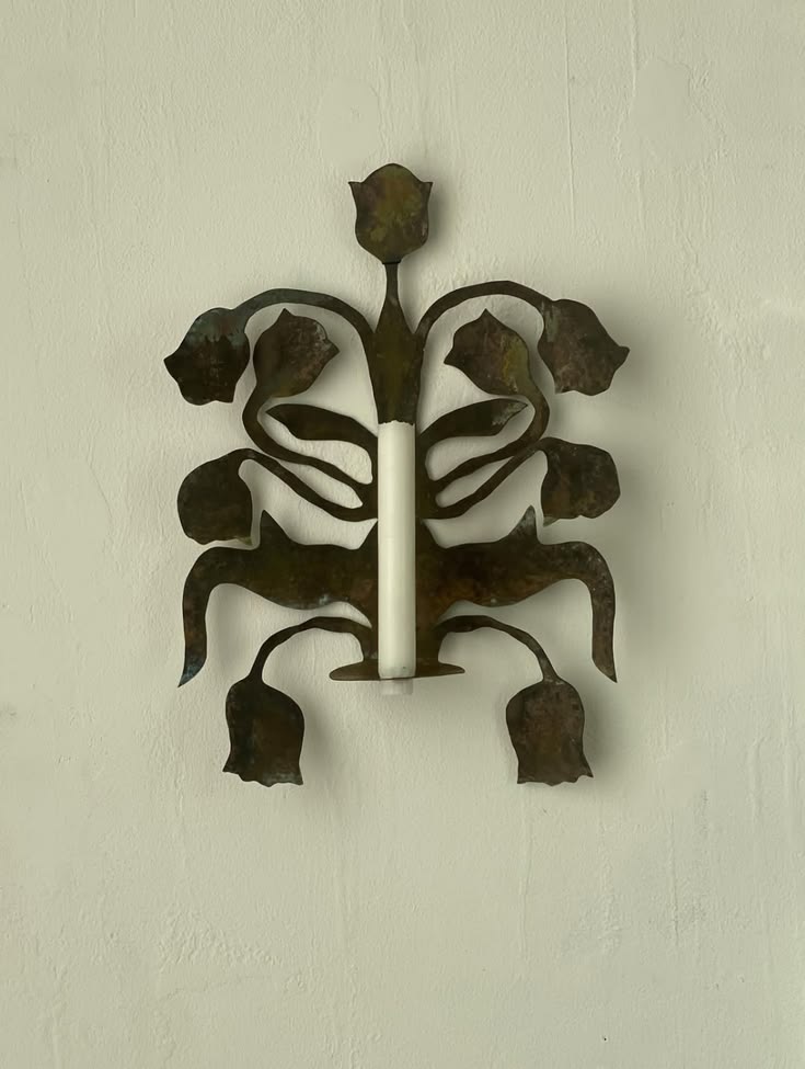 Weathered bronze wall sconce with a tulip and leaf motif