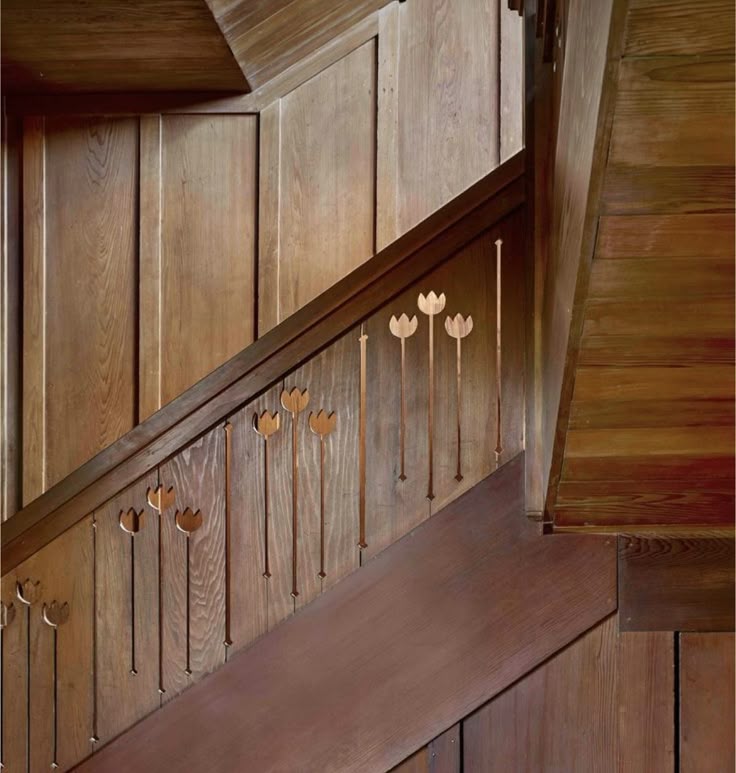 Wood staircase railing with carved tulip flower balusters