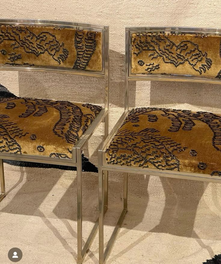 Chrome dining chairs upholstered in gold and black embroidered velvet